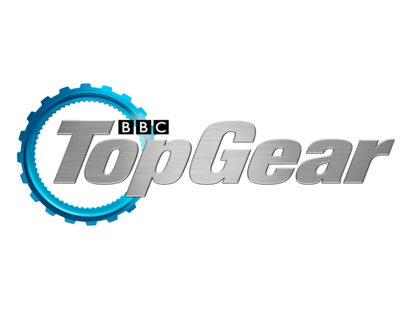 The Top Gear logo featuring a metallic silver 'Top Gear' wordmark with a bright blue circular gear graphic behind it and a small black BBC box logo above the letters, all on a plain white background.